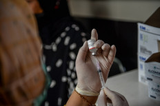 A health worker prepares COVID-19 vaccine for patients at Arcamanik community health center (puskesmas) on Jan. 4, 2024, in Bandung, West Java. 