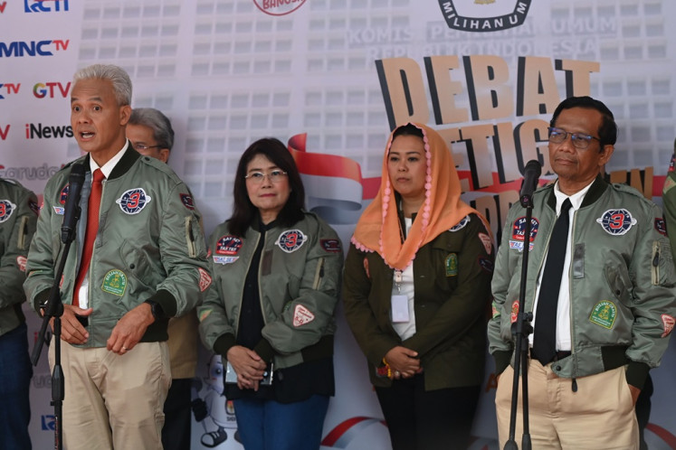 Presidential candidate pair Ganjar Pranowo (left) and Mahfud MD (right) talk to press on Jan. 7, 2024, after the third 2024 presidential election debate, at Istora Senayan in Jakarta. The third debate covered international relations, defense and security.