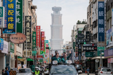 Taiwan's Vice President and presidential candidate of the ruling Democratic Progressive Party (DPP) Lai Ching-te (L) greets supporters on Jan. 8, 2024, during a campaign motorcade tour in Kaohsiung ahead of the presidential election. 