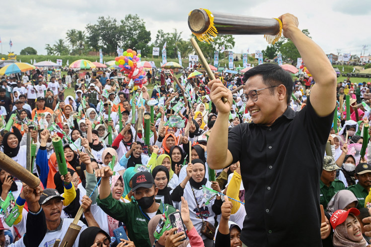 Vice presidential candidate Muhaimin Iskandar (right) hits a traditional slit drum, locally known as "kentongan" in front of his supporters during a campaign event at Simpang Agung field in Central Lampung, Lampung, on Jan. 9, 2024. 