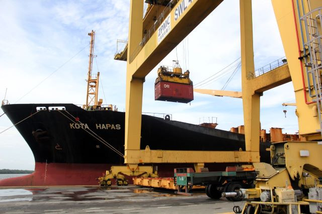 Balancing act: A container is unloaded from a ship by a crane on Jan. 6, 2024 at Belawan Port in Medan, North Sumatra.