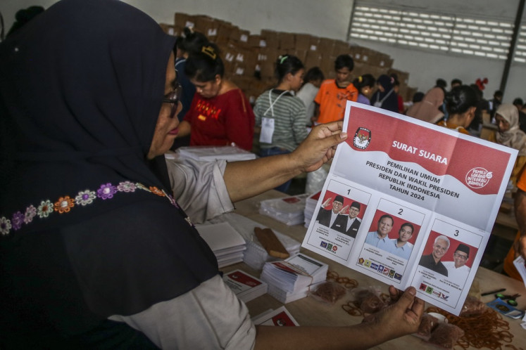 A worker shows a ballot paper for the 2024 presidential election in Pulogadung, Jakarta on Jan. 9, 2024.