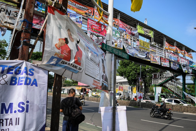 Election campaign banners cover a pedestrian bridge at Jl. K.H. Mas Mansyur in Tanah Abang, Central Jakarta, on Jan. 5, 2024. 