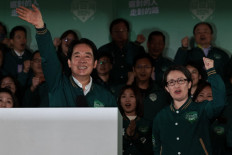 Taiwan's President-elect Lai Ching-te (left) waves beside his running mate Hsiao Bi-khim during a rally outside the headquarters of the Democratic Progressive Party (DPP) in Taipei on January 13, 2024, after winning the presidential election. Taiwan's ruling party candidate Lai Ching-te, branded a threat to peace by China, on January 13 won the island's presidential election, a vote watched closely from Beijing to Washington. 