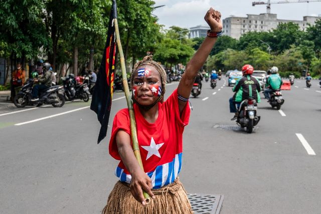 Expression of freedom: A student gestures as she takes part in a rally for an independent Papua near the Surabaya Police headquarters, held on Dec. 1, 2021 to coincide with the anniversary of the Free Papua Movement (OPM).
