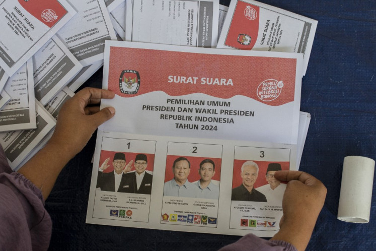 A worker sorts and folds ballot papers for the 2024 presidential election at an election warehouse in Bogor, West Java, on Jan. 15, 2024.