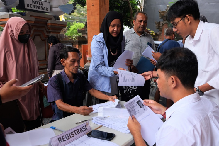 A Denpasar Elections Commission (KPU) official checks the documents submitted by voters who want to change their voting address in Denpasar, Bali, on Jan. 15, 2024. 
