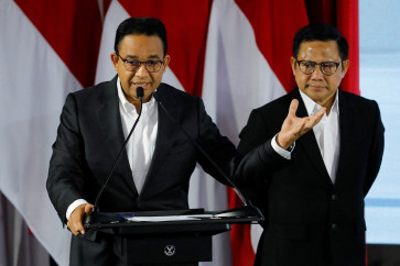 Presidential candidate Anies Baswedan (left), accompanied by his running mate Muhaimin Iskandar, delivers a speech about their campaign platform on anticorruption during the Strengthening Anticorruption for State Apparatus (Paku Integritas) event held by the Corruption Eradication Commission (KPK) in Jakarta on Jan. 17, 2024.