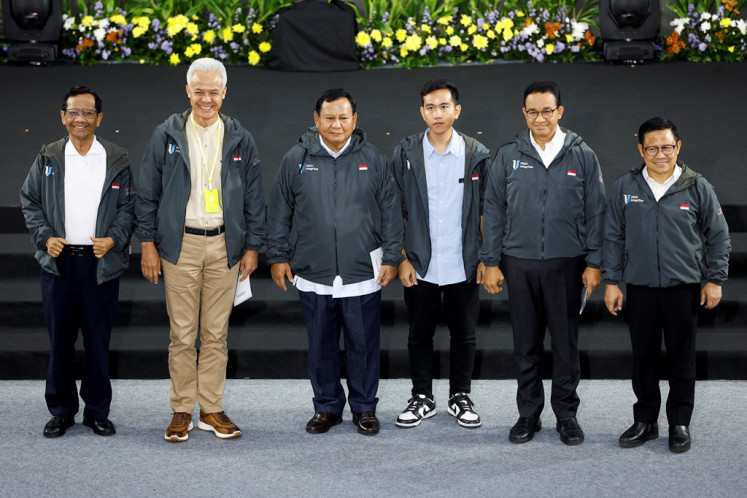 Presidential candidates along with their running mates, (from left to right) Ganjar Pranowo, Mahfud MD, Prabowo Subianto, Gibran Rakabuming Raka, Anies Baswedan and Muhaimin Iskandar, pose for a group photo after delivering their anticorruption vision and mission during the Strengthening Anticorruption for State Apparatus (Paku Integritas) event held by the Corruption Eradication Commission (KPK) in Jakarta on Jan. 17, 2024.