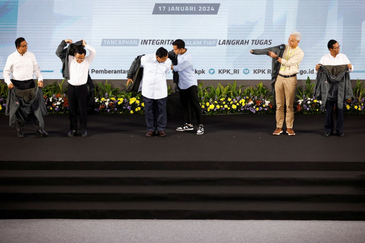 Presidential candidates along with their running mates, (from left to right) Anies Baswedan, Muhaimin Iskandar, Prabowo Subianto, Gibran Rakabuming Raka, Ganjar Pranowo and Mahfud MD, pose for a group photo after delivering their anticorruption vision and mission during the Strengthening Anticorruption for State Apparatus (Paku Integritas) event held by the Corruption Eradication Commission (KPK) in Jakarta on Jan. 17, 2024.