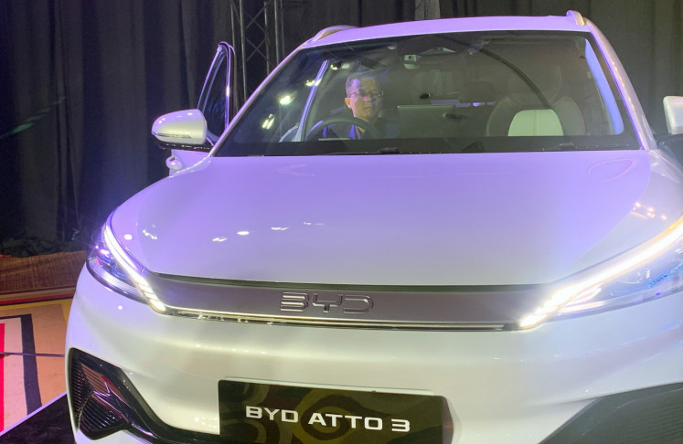 A man inspects the interior of a BYD Atto 3 model at a BYD product launch event in Jakarta on Jan. 18, 2024. 