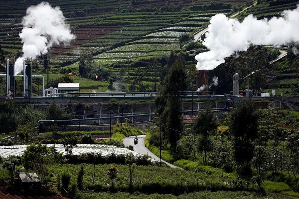 Clean energy: A motorcyclist drives near a geothermal power station operated by PT Geo Dipa Energi in the Dieng mountains in Banjarnegara, Central Java, on Nov. 15, 2020. Businesses across the world have been championing renewable energy in response to climate change.