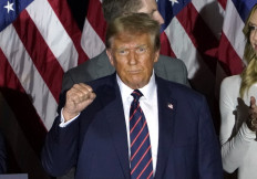 Republican presidential hopeful and former US President Donald Trump gestures during an Election Night Party in Nashua, New Hampshire, on January 23, 2024. Donald Trump won the key New Hampshire primary Tuesday, moving him ever closer to locking in the Republican presidential nomination and securing an extraordinary White House rematch with Joe Biden. 