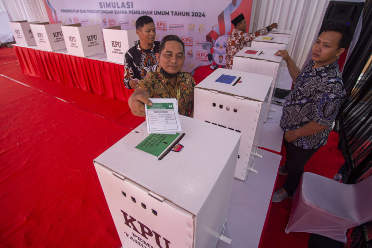 Local residents simulate casting the ballot at a polling station in Indramayu, West Java on Jan. 24, 2024 in preparation for the 2024 general election next month.