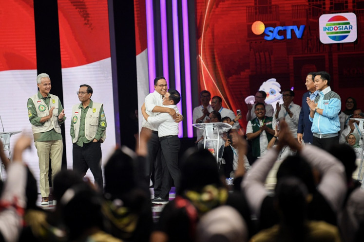 Presidential candidate pair Anies Baswedan (third left) and Muhaimin Iskandar (third right) embrace each other on Jan. 21, 2024, while other candidate pairs Ganjar Pranowo-Mahfud MD (left) and Prabowo Subianto-Gibran Rakabuming Raka (right) look on, after the second 2024 vice presidential debate at Jakarta Convention Center (JCC) in Jakarta.