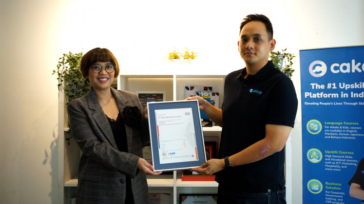 PT SGS Indonesia Director of Knowledge, Waras Putri Andrianti presents the ISO 27001:2022 certificate to Yohan Limerta.