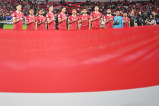 Players of the Indonesian men's soccer team line up on Jan. 15, 2024 to sing the national anthem prior to their 2023 AFC Asian Cup Group D soccer match against Iraq at Ahmad bin Ali Stadium in Al Rayyan, Qatar.