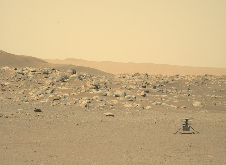 This NASA photo obtained July 25, 2021 shows NASA's Ingenuity Mars Helicopter (right) captured by Mars Perseverance rover using its Left Mastcam-Z Camera, composed of a pair of cameras located high on the rover's mast, on June 15, 2021. NASA's Ingenuity Mars helicopter has made its final flight after sustaining damage to “one or more“ of its rotor blades, the US space agency said on Jan. 25, 2024. The mini-aircraft made history by achieving the first powered, controlled flight on another planet on April 19, 2021, and the last of its 72 flights took place on January 18, a statement said.