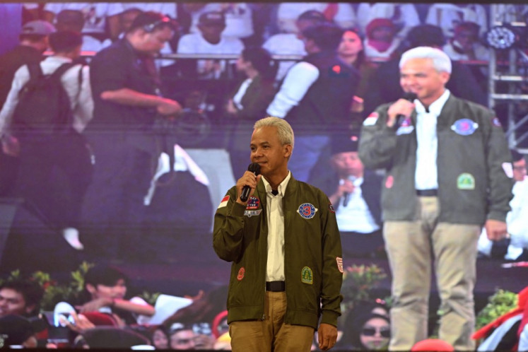 Presidential candidate and former Central Java governor Ganjar Pranowo (center) is greeted by supporters during campaigning for the Feb. 14 general election in Surabaya, East Java, on Jan. 13, 2024.