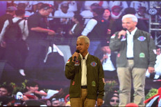 Presidential candidate and former Central Java governor Ganjar Pranowo (center) is greeted by supporters during campaigning for the Feb. 14 general election in Surabaya, East Java, on Jan. 13, 2024.