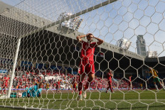 Indonesia's goalkeeper #21 Ernando Ari (in blue) concedes a goal during the Qatar 2023 AFC Asian Cup football match between Australia and Indonesia at the Jassim bin Hamad Stadium in Doha on January 28, 2024. 