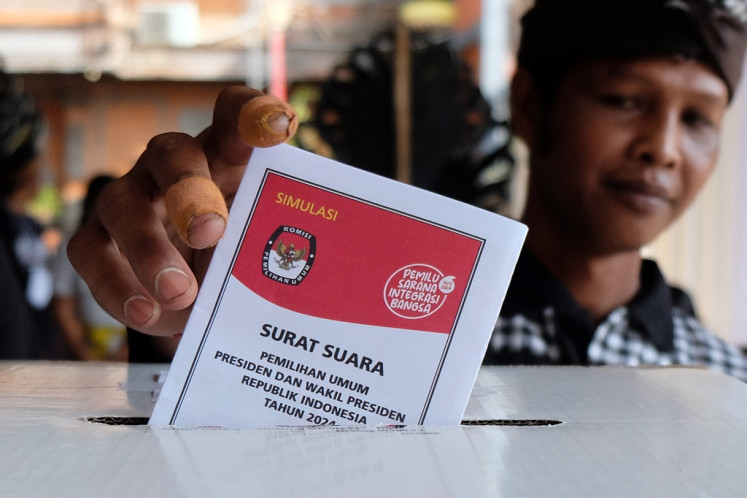 A voter inserts a ballot paper into a ballot box during a voting simulation exercise in Denpasar, Bali, on Jan. 28, 2024. The simulation was intended to help poll administrators and voters understand what to do on voting day on Feb. 14, 2024.