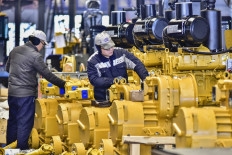 Employees work on an assembly line producing wheel loaders at a factory in Qingzhou, in eastern China's Shandong province on Jan. 17, 2024.