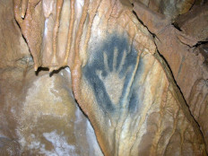 The 27,000-year-old silhouette of a right hand, painted by aerosol dispersal of pigment on a subterranean stalagtite curtain, appears in this handout photo of a wall of the Grotte de Vilhonneur released 02 June 2006 at Vilhonneur. 