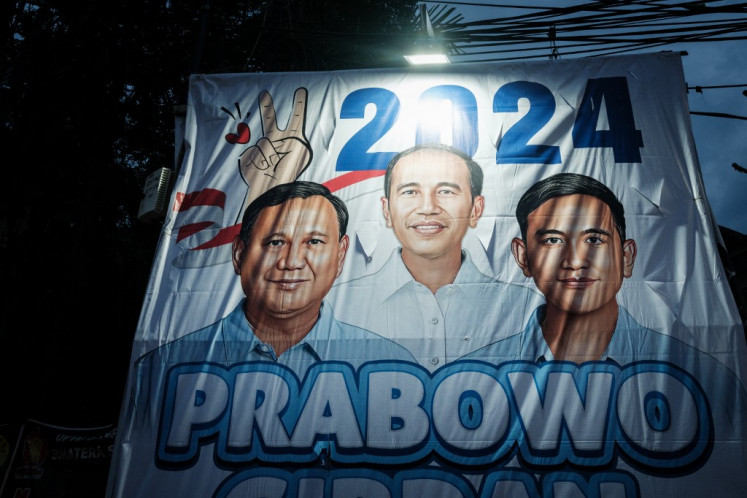 Campaign posters of presidential candidate and Defence Minister Prabowo Subianto and vice presidential candidate Gibran Rakabuming Raka, son of President Joko “Jokowi“ Widodo and current mayor of Surakarta, are seen along a street in Jakarta on January 31, 2024, ahead of the presidential and legislative polls scheduled to be held on February 14. 