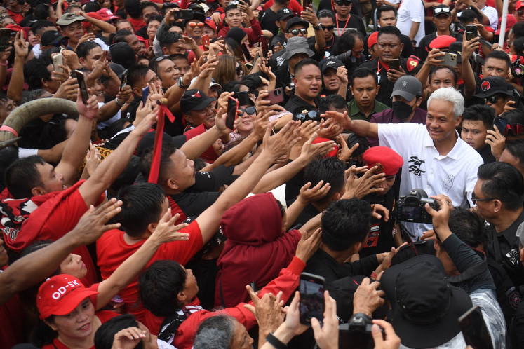 Presidential candidate Ganjar Pranowo (right) greets his supporter during a campaign event in Manado, North Sulawesi on Feb. 1, 2024. During the event, Ganjar calls for his supporters to keep voicing their support for him and running mate Mahfud MD despite pressures from other camps.
