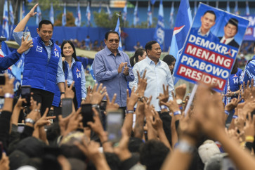 Presidential candidate Prabowo Subianto (right, in white shirt) appears at a campaign event on Feb. 1, 2024 hosted by the Democratic Party in Malang, East Java, alongsited with former president and party founder Susilo Bambang Yudhoyono (second left) and party chairman Agus Harimurti Yudhoyono (left).