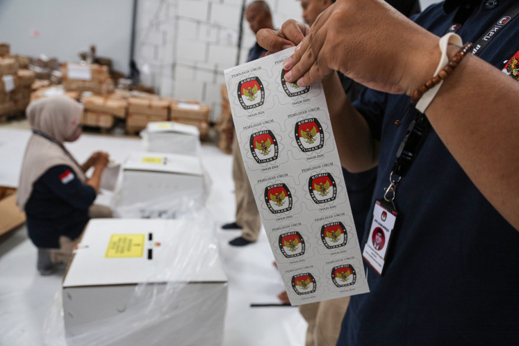 A worker readies seals for ballot boxes at a logistics warehouse of the Semarang Elections Commission (KPU) in Semarang, Central Java, on Jan. 31, 2024.
