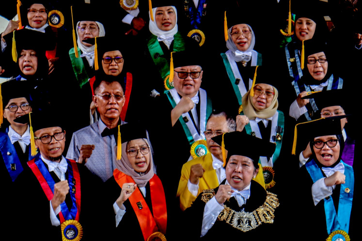 University of Indonesia board of professors head Harkristuti Harkrisnowo (front, second right) delivers a speech at the university's campus in Depok, West Java, on Feb. 2, 2024. The professors flagged what they said was democratic decline in the country ahead of the 2024 general election.