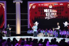 Presidential candidates Anies Baswedan (left), Prabowo Subianto (center) and Ganjar Pranowo stand on the stage during the final 2024 presidential debate at the Jakarta Convention Center (JCC) in Senayan, Central Jakarta, on Feb. 4, 2024.