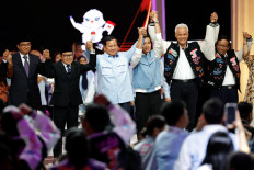 Presidential candidates Anies Baswedan, Prabowo Subianto and Ganjar Pranowo along with their running mates, Muhaimin Iskandar, Gibran Rakabuming Raka, who is the eldest son of Indonesian President Joko “Jokowi“ Widodo, and Mahfud MD respectively hold hands before a group photo after a televised debate ahead of the general election at the Jakarta Convention Center in Jakarta,, February 4, 2024.
