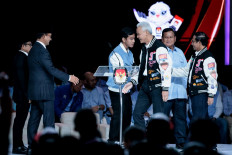 Presidential candidate and former Jakarta governor Anies Baswedan (second left), vice presidential candidate Muhaimin Iskandar (left), presidential candidate and Defence Minister Prabowo Subianto (second right), vice presidential candidate Gibran Rakabuming Raka (third left), presidential candidate and former Central Java governor Ganjar Pranowo (third right) and vice presidential candidate Mahfud MD react on the stage during the final presidential election debate at the Jakarta Convention Center (JCC) in Jakarta on Feb. 4, 2024. 