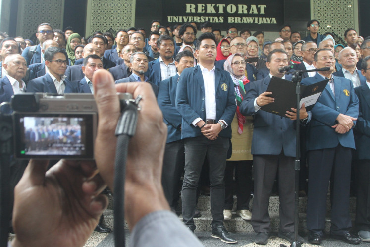 Students and professors of Brawijaya University deliver a speech at the university's campus in Malang, East Java on Feb. 6, 2024. The university's professors and students urge the government to be impartial and push for a fair law enforcement ahead and during the 2024 general election.