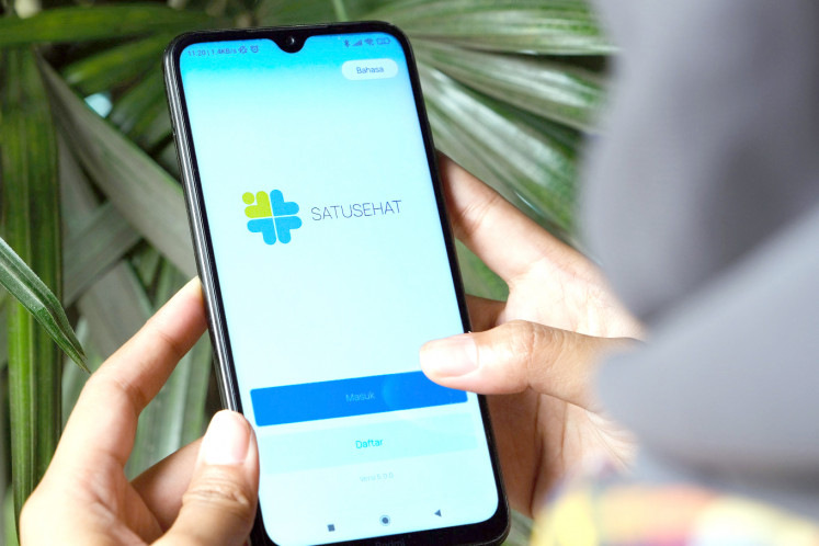 A person opens the Satusehat Mobile app in Pontianak, West Kalimantan, in this file photo.