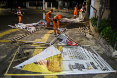 Jakarta city workers remove election campaign banners in Menteng, Jakarta, on Feb. 11, 2024. The Jakarta administration  has deployed joint personnel to remove campaign banners during the silent period for the 2024 general election between Feb. 11 and 13 ahead of the voting day.