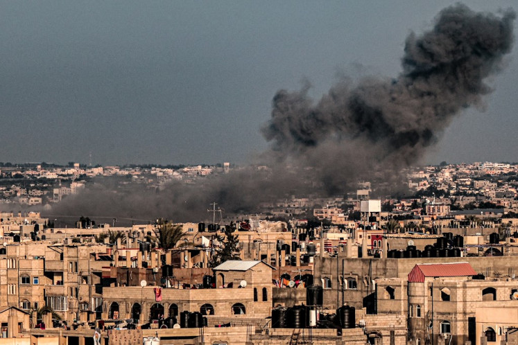 A smoke plume erupts during Israeli bombardment over Rafah in the southern Gaza Strip on February 11, 2024, amid the ongoing conflict between Israel and the Palestinian militant group Hamas. 