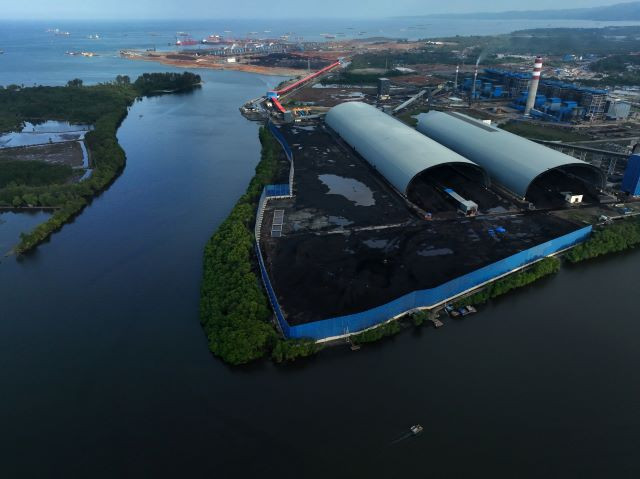 A river flows past a nickel smelter belonging to PT Virtue Dragon Nickel Industry and PT Obsidian Stainless Steel on Feb. 8, 2024, at the Morosi Industrial Estate in Konawe regency, Southeast Sulawesi.