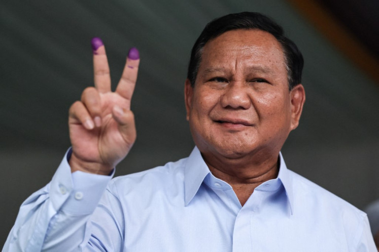 Presidential candidate Prabowo Subianto gestures after he cast his ballot in the country's presidential and legislative elections at a polling station in Bogor, West Java, on Feb. 14, 2024. 