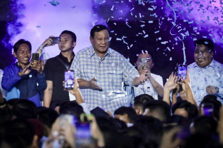 Presidential candidate Prabowo Subianto (center) dances on the stage during a gathering with supporters.