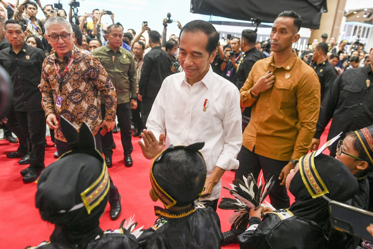 President Joko “Jokowi“ Widodo greets dancers on Feb. 15, 2024, during the opening ceremony of 2024 Indonesian International Motor Show (IIMS) at JIExpo Kemayoran in Jakarta.