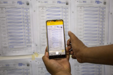 A local poll administrator (KPPS) takes a photo of vote tabulation forms during an election simulation on Feb. 7, 2024 in Indramayu, West Java.