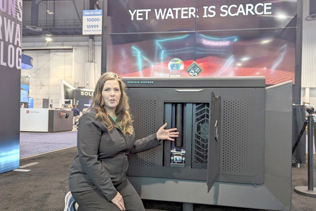 Genesis Systems cofounder Shannon Stuckenberg showcases a WaterCube device that extracts water from the air on Jan. 12, 2024, during the Consumer Electronics Show in Las Vegas. 