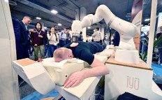 A person uses the iYU, a hands-free robotized massage bed from Capsix Robotics, on Jan. 11, 2024, at the Venetian Expo Center during the Consumer Electronics Show in Las Vegas, Nevada, the United States. 