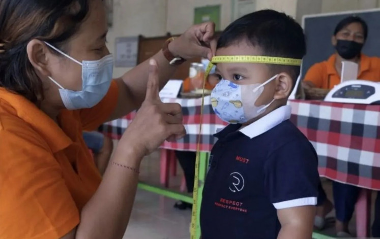 A level head: A volunteer measures the diameter of a child’s head on Jan. 18, 2023, at an integrated health services post (Posyandu) in Gelogor hamlet in Denpasar, Bali, as part of the country’s fight against stunting and malnutrition in children.

