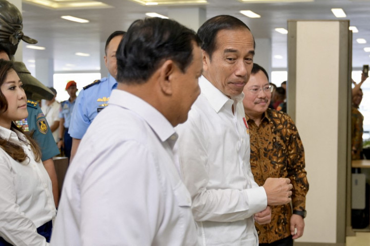 President Joko “Jokowi“ Widodo (right) speaks with Defense Minister and presidential candidate Prabowo Subianto (left) before the inauguration of the National Defense Central Hospital (RSPPN) in Jakarta on Feb. 19, 2024.