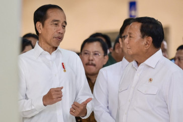 President Joko 'Jokowi' Widodo (left) speaks with Defense Minister and presidential candidate Prabowo Subianto (right) on Feb. 19, 2024, before the inauguration of the National Defense Central Hospital (RSPPN) in Jakarta.